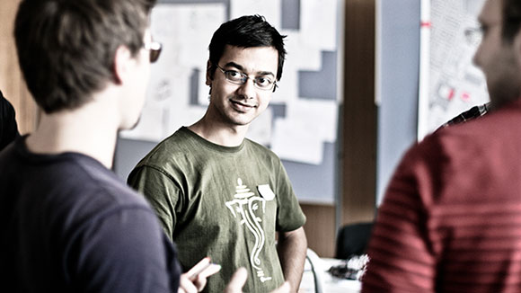 Three young people in an animated conversation.