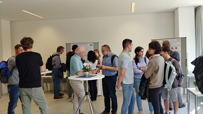 Students and professors exchange ideas during the poster presentation.