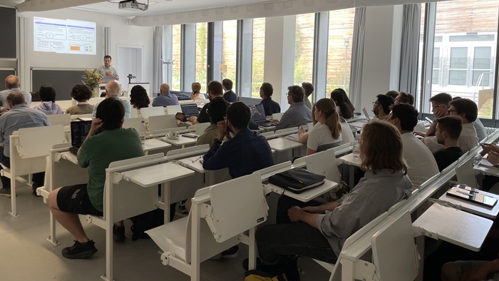 Students and Professors are listening to a presentation.