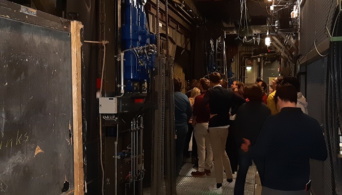 A group of young people in a machine room.