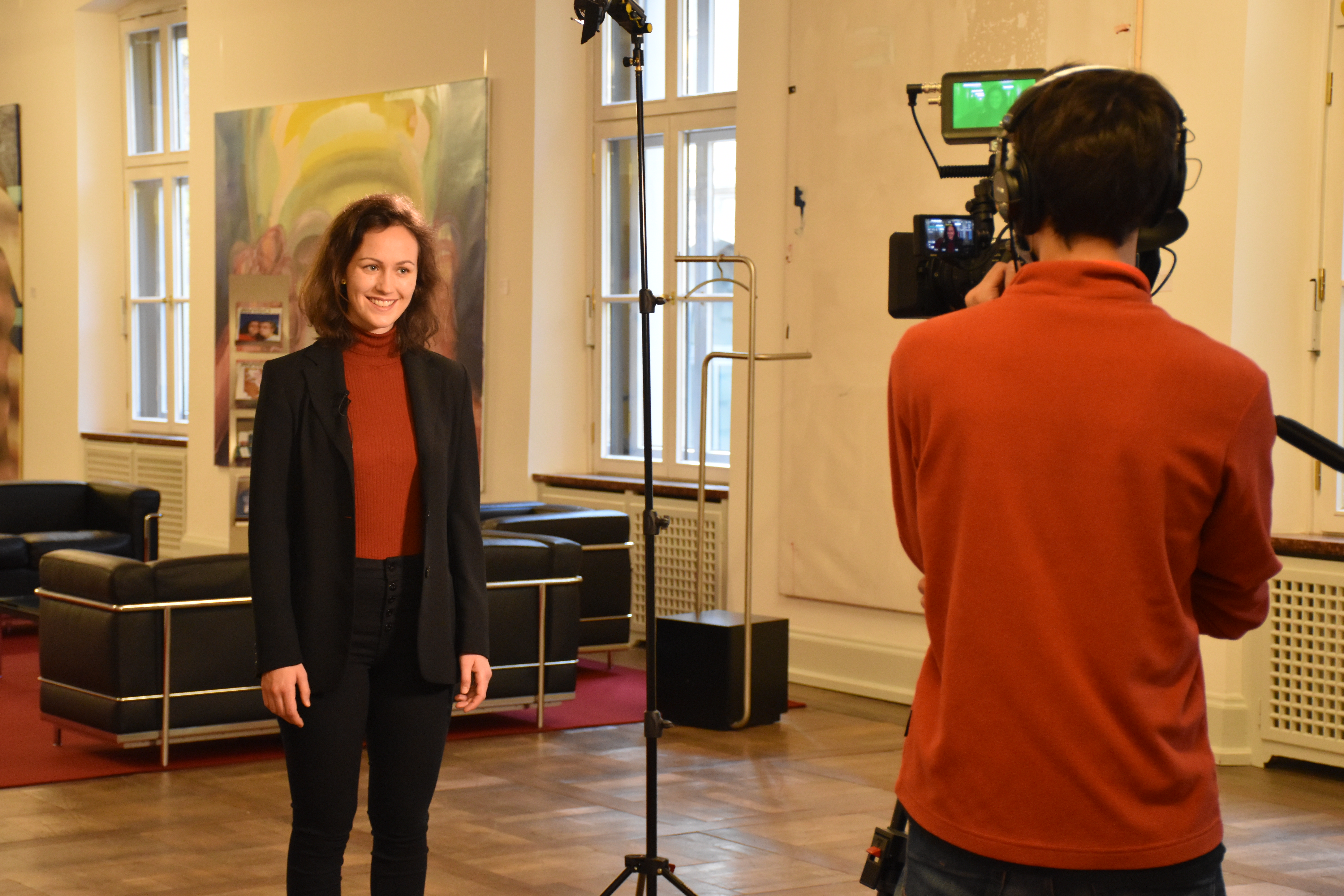 A woman is filmed by a cameraman. 