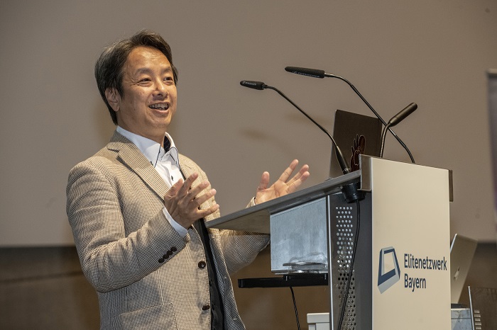 A man stands at a lectern.