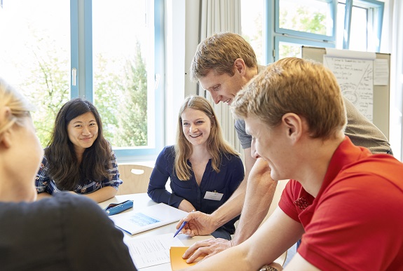  A group of young people is led by a lecturer.