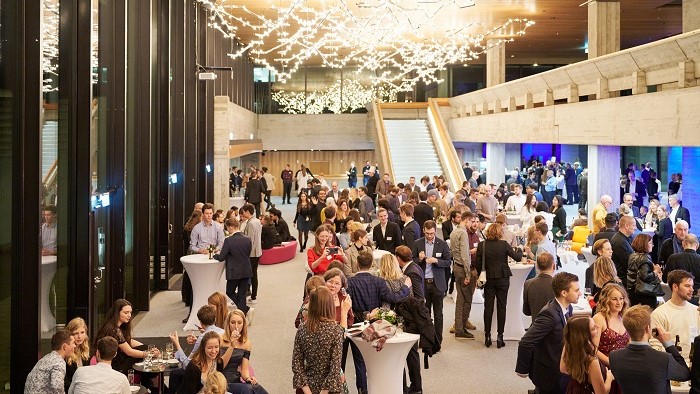 Decorated reception hall filled with graduates