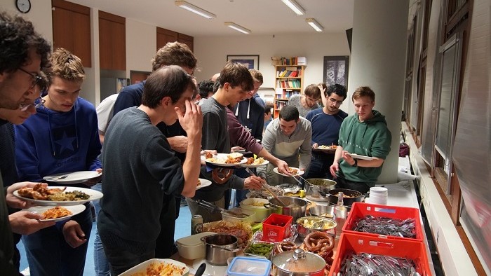 Students help themselves to a buffet with many different dishes.