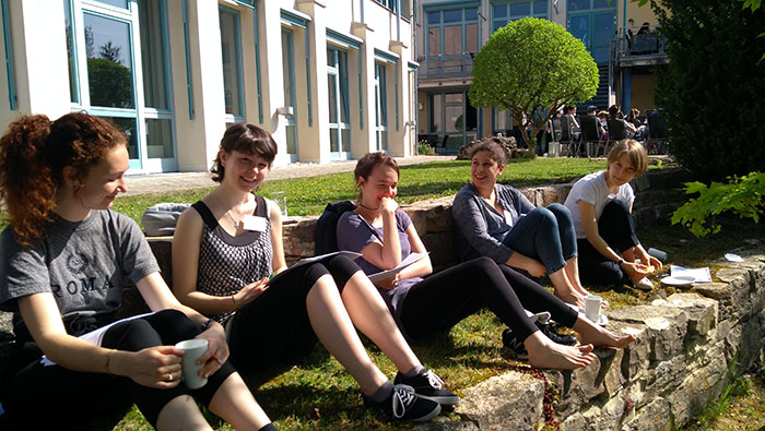 A group of young women sitting outdoors and chatting on a lovely summer’s day.